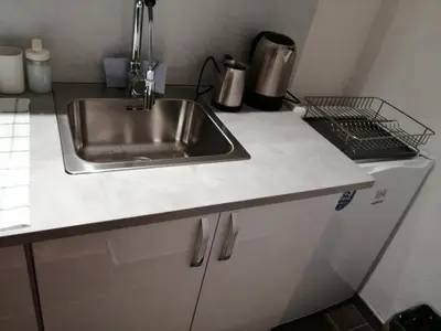 a kitchen with a sink and a counter top at Park 1 MARKO FREE PARKING in Vranje