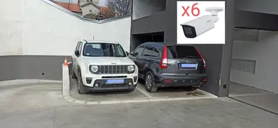 two cars parked next to each other in a garage at Lux apartment 8, center, free parking in Niš