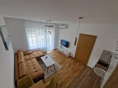 a living room with a couch and a table at Nina Apartman 3 in Soko Banja