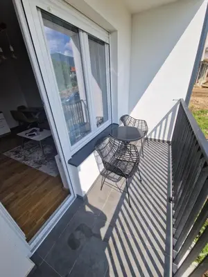a balcony with two chairs and a table at Nina Apartman 3 in Soko Banja