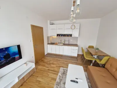 a living room with a couch and a table at Nina Apartman 3 in Soko Banja