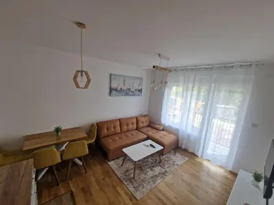 a living room with a couch and a table at Nina Apartman 3 in Soko Banja