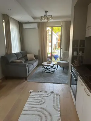 a living room with a couch and a table at Royal King in Vrnjačka Banja