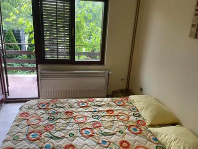 a bedroom with a bed in front of a window at Hostel Drenak in Gornje Rataje