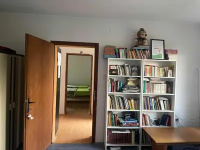 a room with a book shelf filled with books at Hostel Drenak in Gornje Rataje