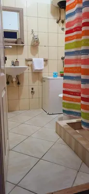 a bathroom with a tiled floor and a sink at Apartman Marta in Vrnjačka Banja