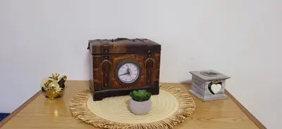 an old clock sitting on a table with a potted plant at Apartman Marta in Vrnjačka Banja