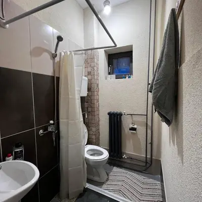 a bathroom with a shower and a toilet and a sink at Calipso1 in Niš