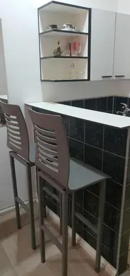 a table and two chairs in a kitchen at Calipso1 in Niš