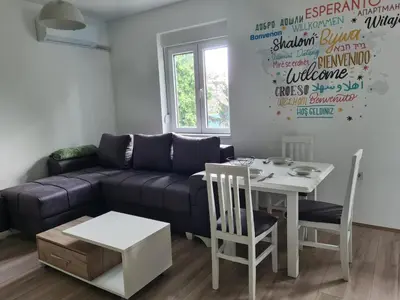 a living room with a couch and a table at Apartment Esperanto next to the Aqua Park in Jagodina
