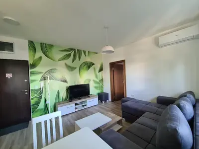 a living room with a couch and a tv at Apartment Esperanto next to the Aqua Park in Jagodina