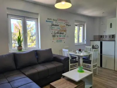 a living room with a couch and a table at Apartment Esperanto next to the Aqua Park in Jagodina