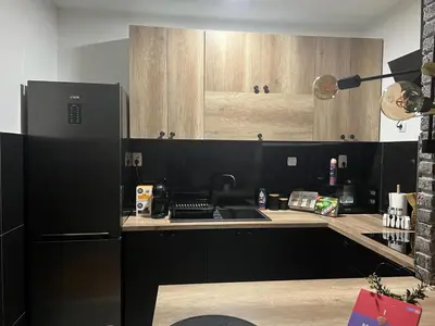 a kitchen with a black refrigerator and a sink at Loft Luxury Apartment in Pirot