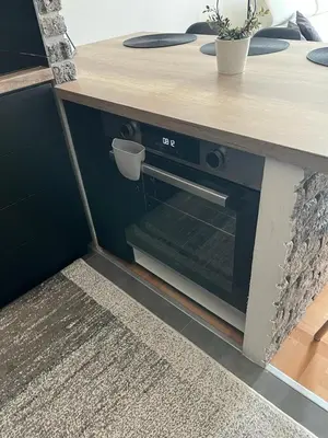 a table with an oven in a room at Loft Luxury Apartment in Pirot