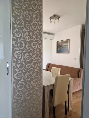 a dining room with a table and a couch at Esperanto in Vranje