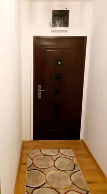 a brown door with a rug in front of it at Esperanto in Vranje