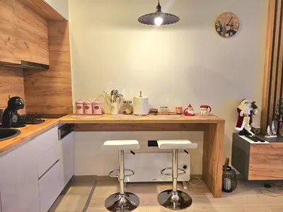 a kitchen with a counter with stools in it at Mon réve Nlux79 in Kopaonik