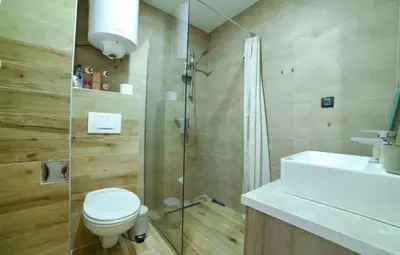 a bathroom with a shower and a toilet and a sink at Mon réve Nlux79 in Kopaonik