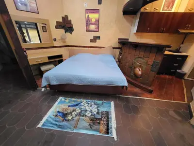 a bedroom with a bed and a rug on the floor at LENA Apartman 45m2 Sokobanja-CENTAR in Soko Banja