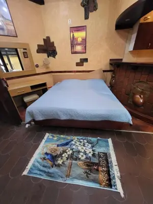 a bedroom with a bed and a rug on the floor at LENA Apartman 45m2 Sokobanja-CENTAR in Soko Banja