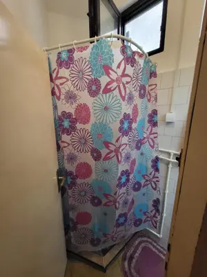 a shower curtain with flowers on it in a bathroom at LENA Apartman 45m2 Sokobanja-CENTAR in Soko Banja