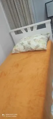a bed with a pillow on top of it at LENA Apartman 45m2 Sokobanja-CENTAR in Soko Banja