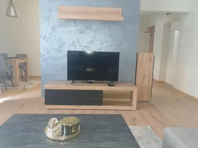a living room with a flat screen tv on a table at SANI in Vrnjci