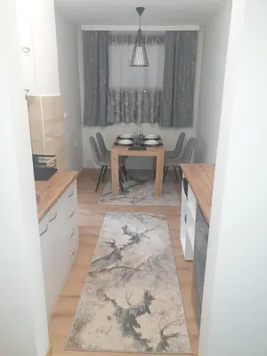 a kitchen with a table and a dining room at SANI in Vrnjci
