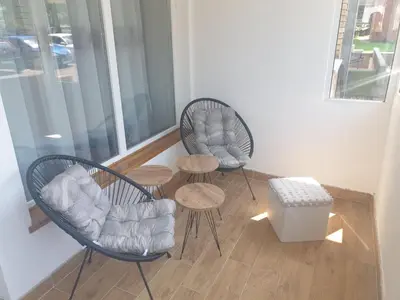 two chairs and a table in a room at SANI in Vrnjci