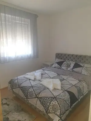 a bedroom with a bed with two pillows on it at SANI in Vrnjci