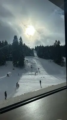 a group of people skiing down a snow covered slope at MONTANA apartment 9 in Kopaonik