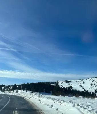 an empty road with snow on the side of it at MONTANA apartment 9 in Kopaonik