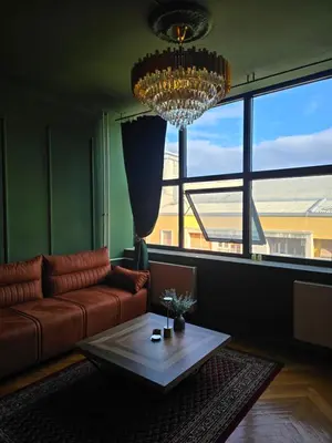 a living room with a couch and a table at Diamond Apartments Niš in Niš