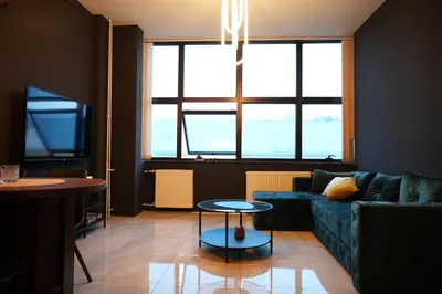 a living room with a couch and a table at Diamond Apartments Niš in Niš