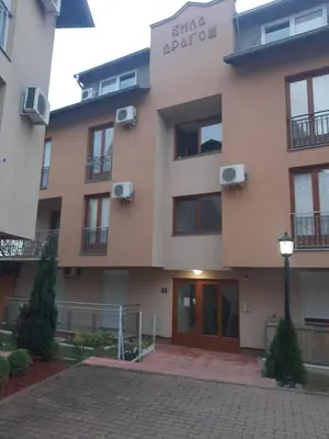 a building with a sign on the side of it at Zlatni apartman in Vrnjačka Banja