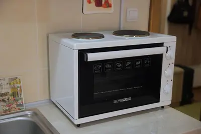 a white oven sitting on top of a kitchen counter at Zlatni apartman in Vrnjačka Banja