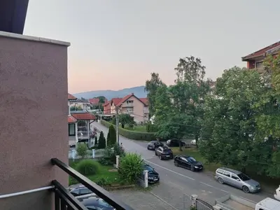 a view of a city street with cars parked at Apartmani Zvezdana in Vrnjačka Banja