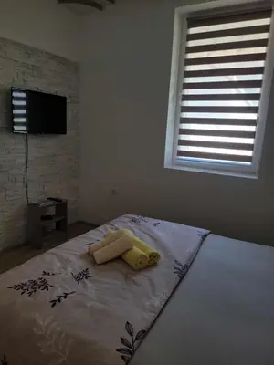 a bedroom with a bed with two towels on it at Apartmani Zvezdana in Vrnjačka Banja