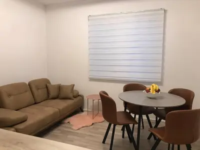 a living room with a couch and a table with chairs at Race for Space in Niš