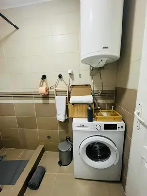 a small bathroom with a washing machine in it at Race for Space in Niš