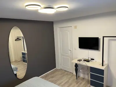a bedroom with a mirror and a bed and a desk at Race for Space in Niš