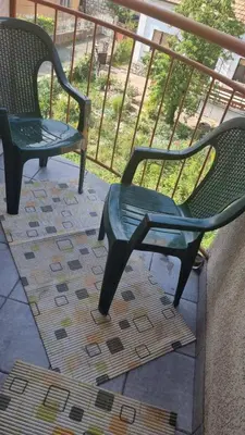 two green chairs sitting on top of a balcony at Aleksandar in Pirot