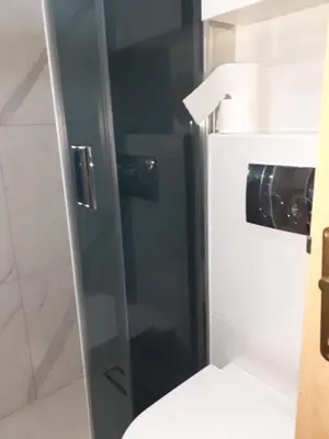 a glass shower door in a bathroom with a toilet at Aleksandar in Pirot