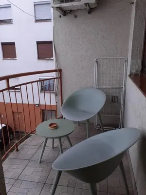 two chairs and a table on a balcony at Aleksandar in Pirot