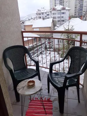 two chairs and a table on a balcony at Aleksandar in Pirot