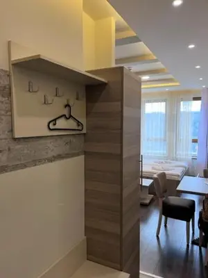 a lobby with a table and chairs in a room at Majapartman in Kopaonik