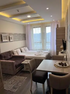 a living room with a couch and a table at Majapartman in Kopaonik