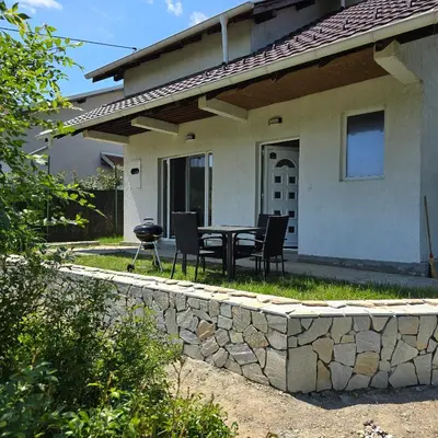 a patio with a table and chairs in front of a house at Sienas Holiday Home in Vrnjačka Banja