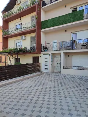 an empty parking lot in front of a building at MP Apartman in Soko Banja