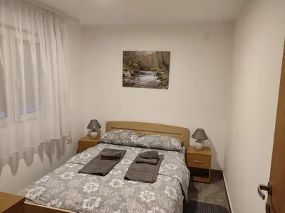 a bedroom with a bed with two towels on it at MP Apartman in Soko Banja